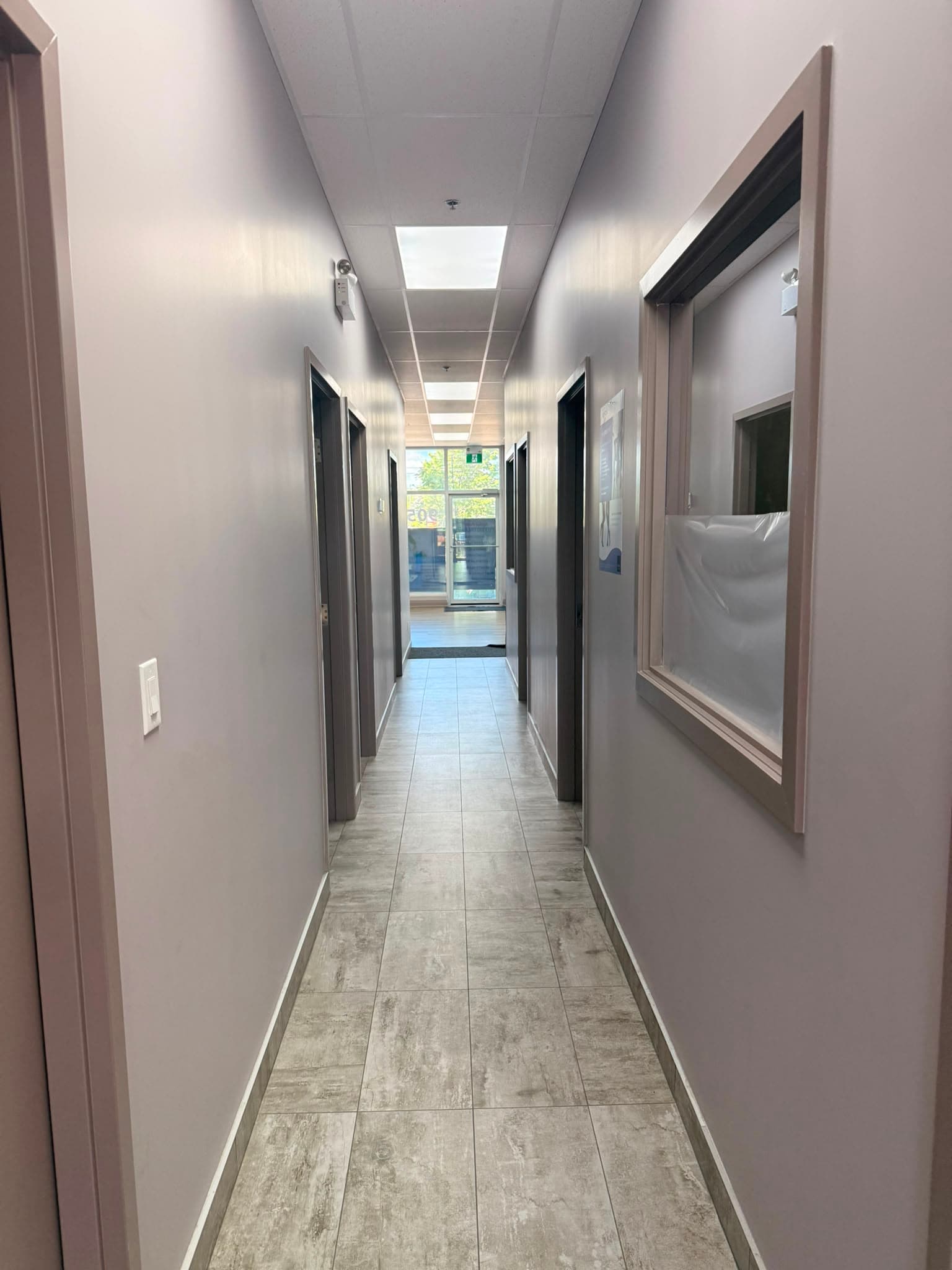 Private treatment rooms along the clinic hallway